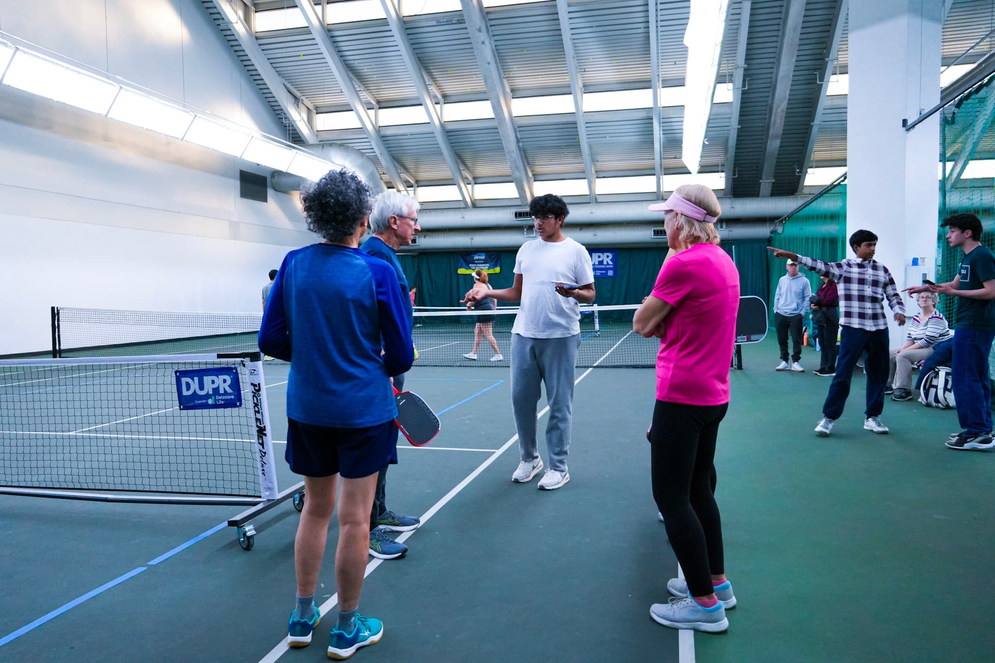 Chill N' Dill — student organizer briefing players court-side