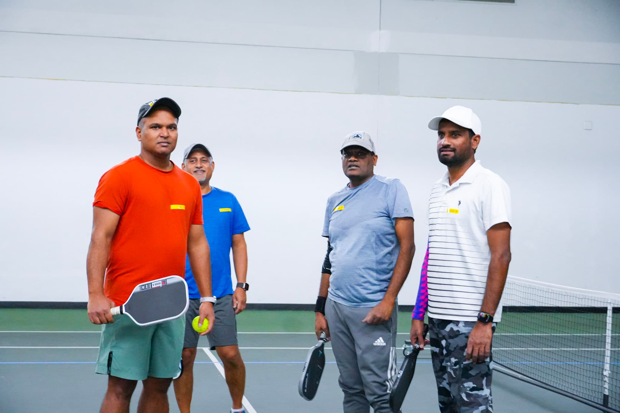 Four CourtQuest players ready at the net on tournament day